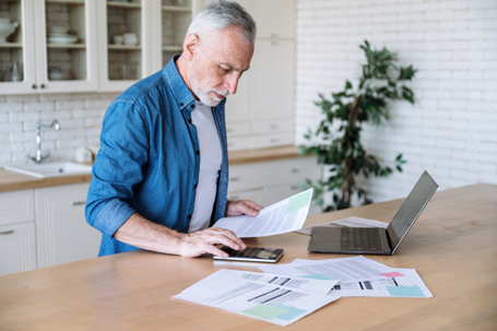 Focused middle-aged man looking at financial documents