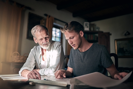 Father and son going over documents